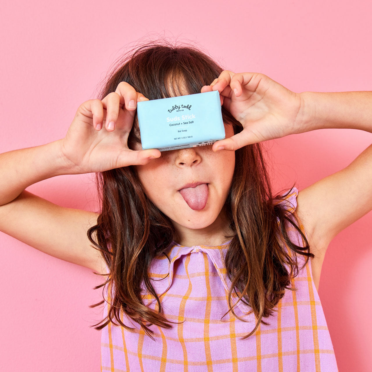Child holding Suds Stick Bar Soap in front of face
